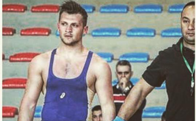 Samir Chebbo in a blue singlet at a wrestling competition